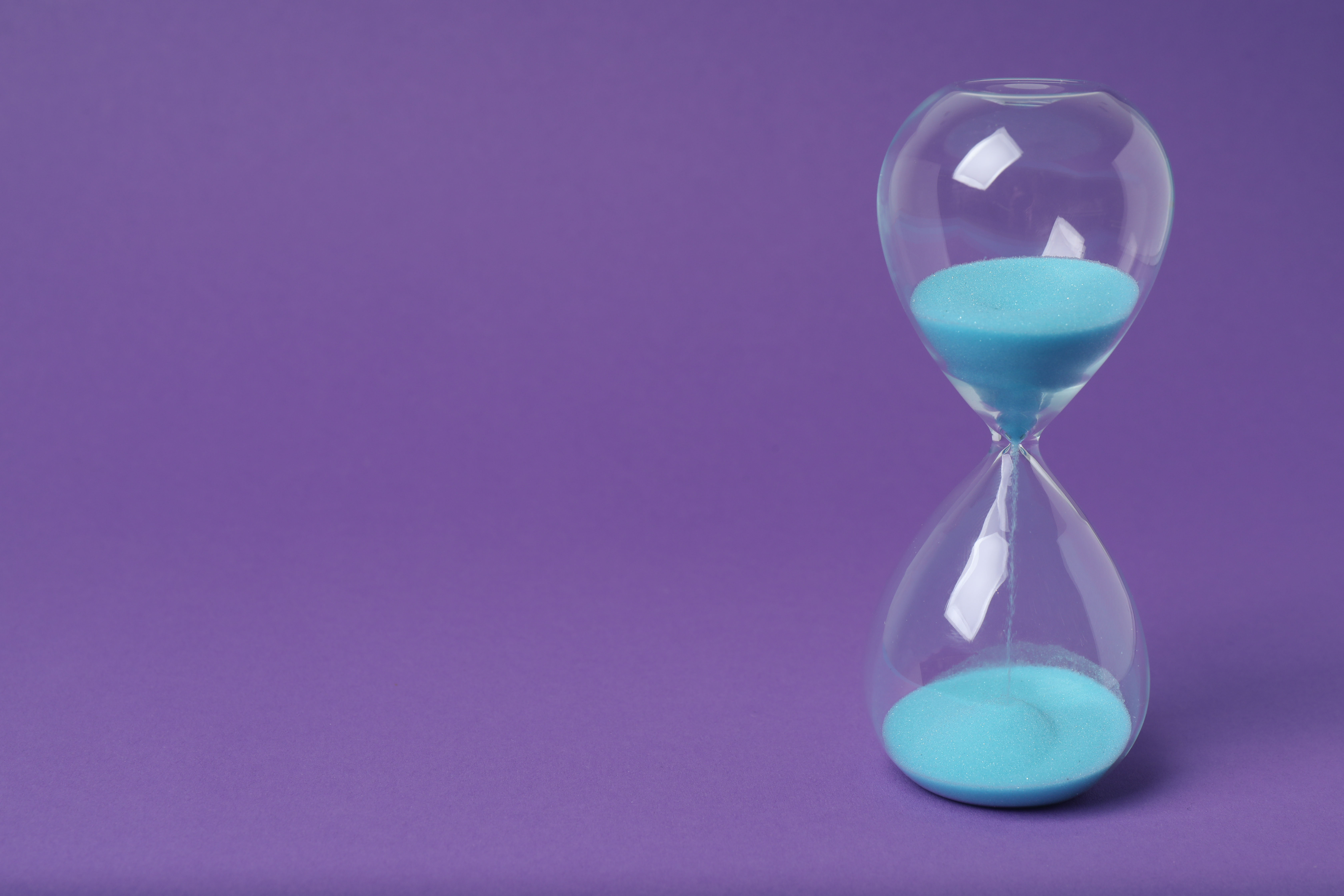 Hourglass with sand flowing — measuring AI ROI in hours.