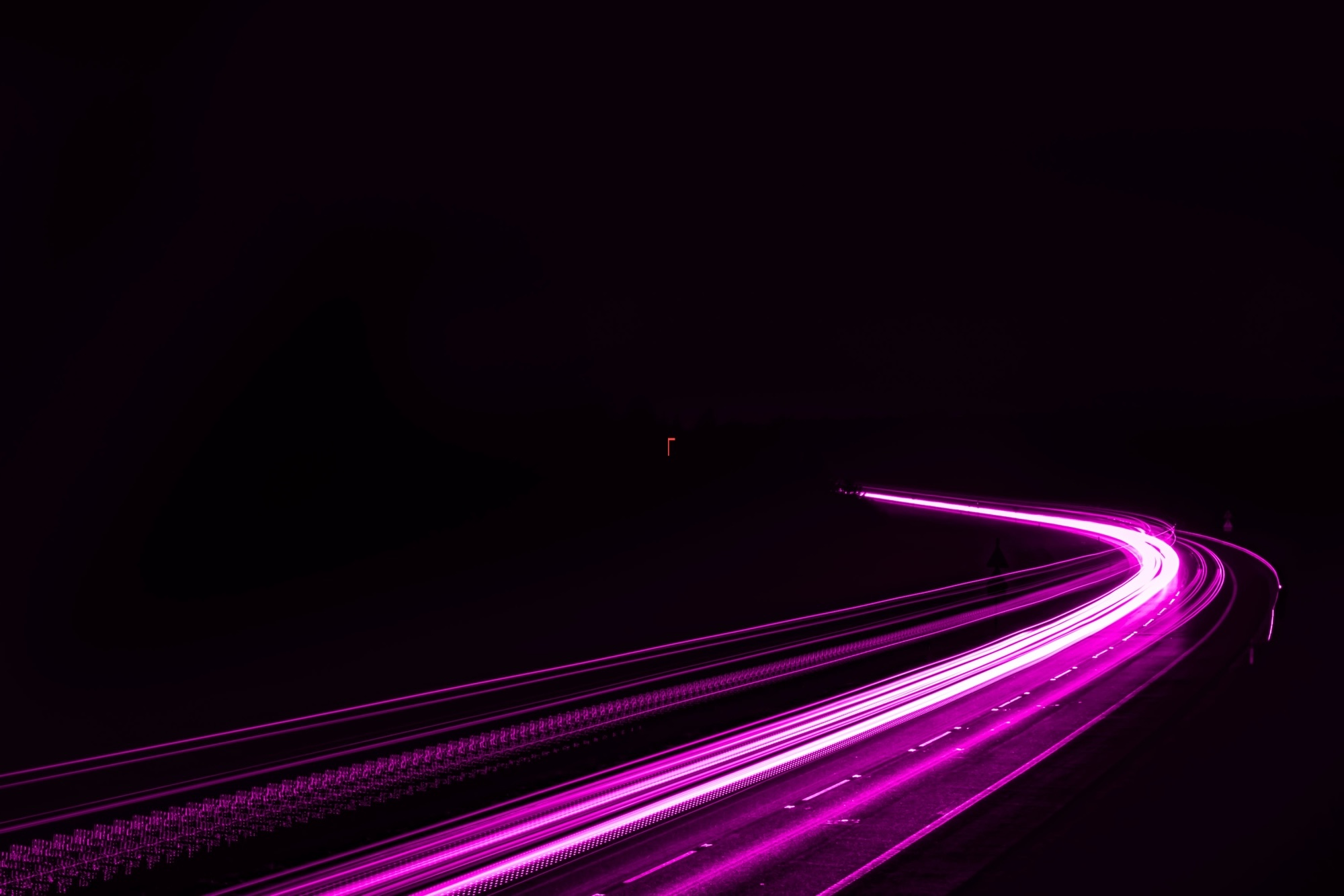 Magenta light trails on a dark highway — agentic AI clearing the path for your team.
